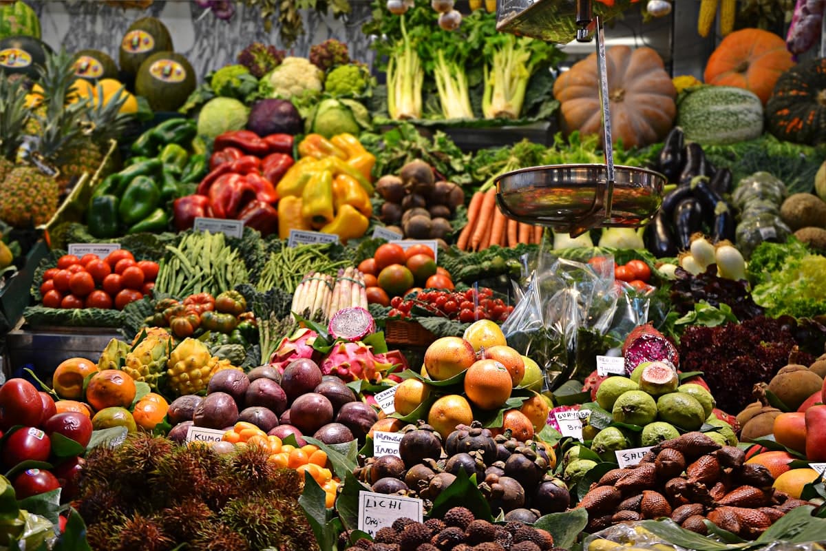 Market vendor behind a stall of fresh produce