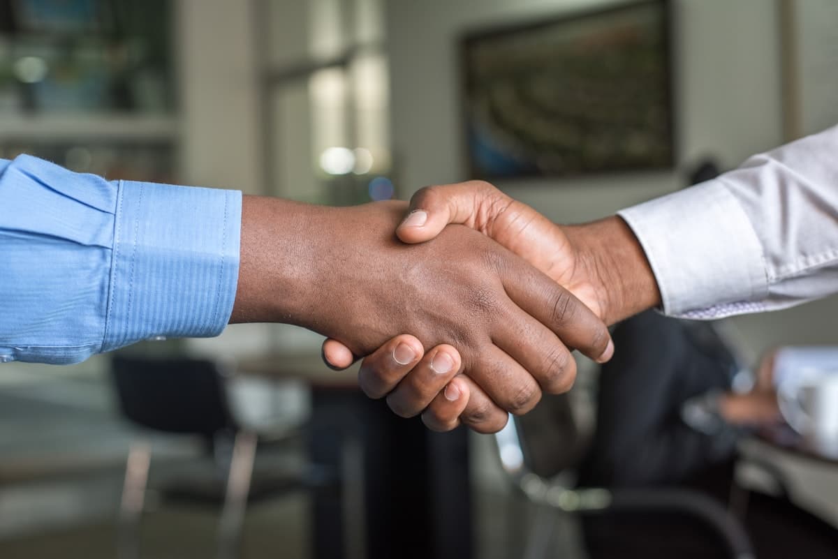 Vendors sealing a referral with a handshake